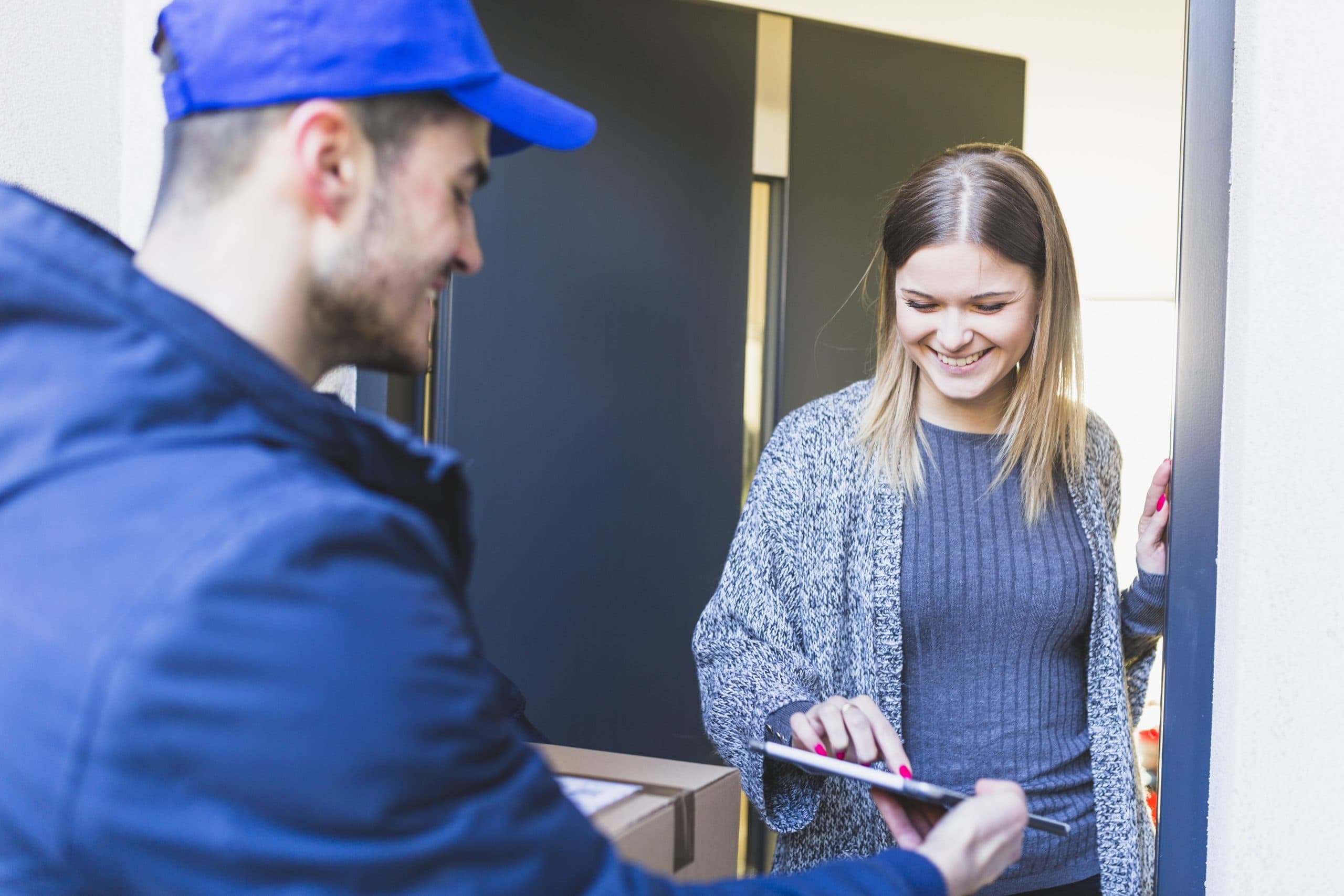 Courier collecting a signed parcel at a customer's door